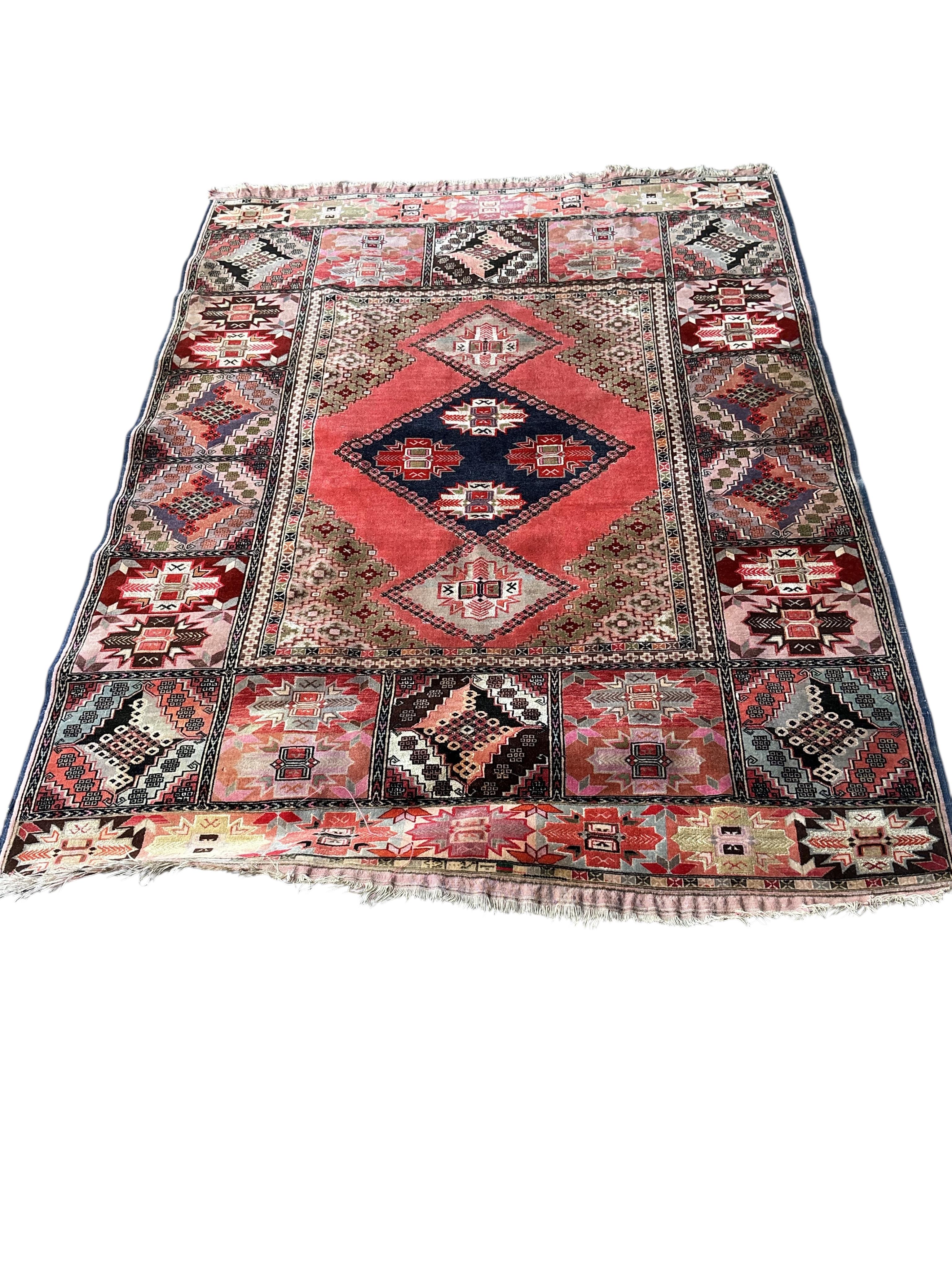 A North West Persian peach ground part silk rug and a Caucasian style rug, larger 175 x 126cm
